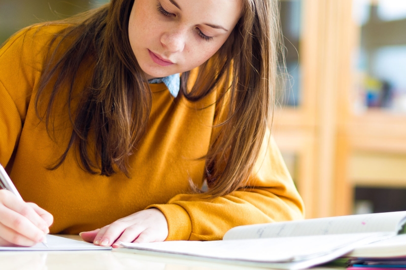 Photo of female college student writing