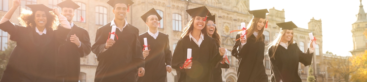 Photo of college graduates walking with their diplomas