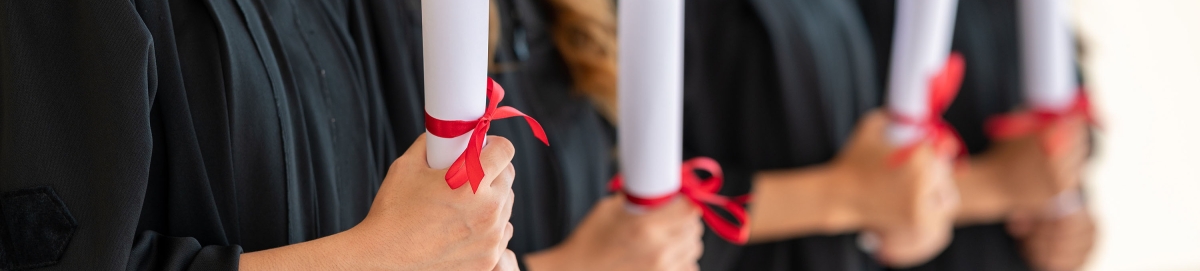 Photo of college graduates holding diplomas