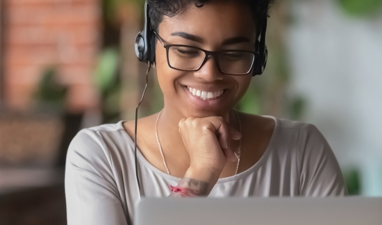 Black female student participating in webinar.