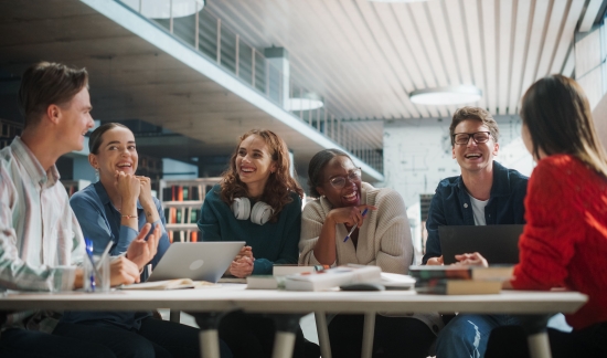 Group of diverse college students smiling while meeting.