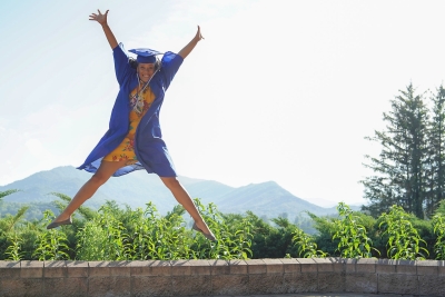 Female graduate jumping in excitement