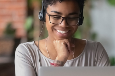 Black female student participating in webinar.