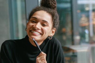Photo of smiling woman in college campus.