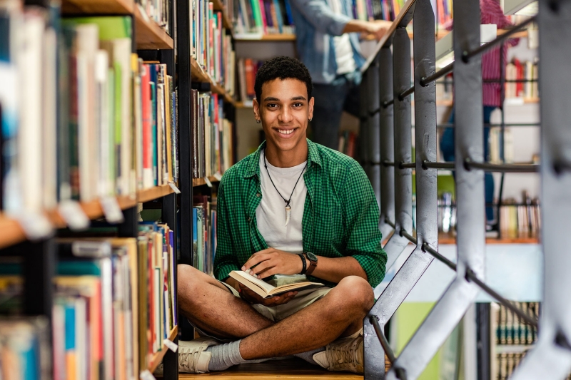 Male student at college library