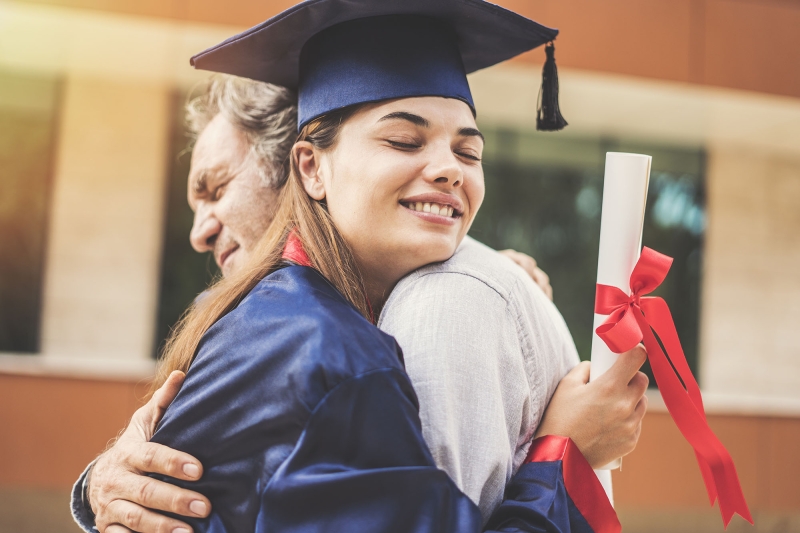 Photo of father hugging daughter at her graduation